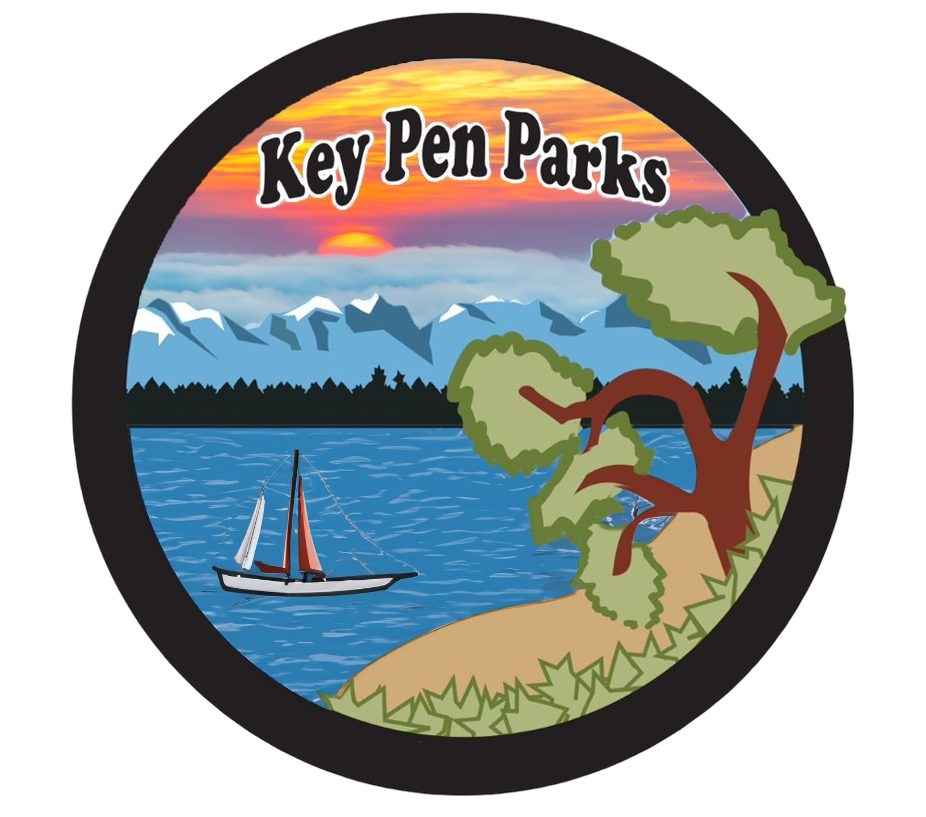 key pen parks logo with madrona, beach, boat, water and mountains